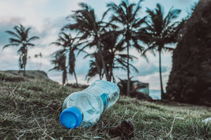 Photo of empty plastic bottle littered on the beach